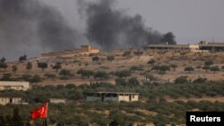 Smoke rises from the Syrian border town of Jarablus, where militant positions were attacked by Turkish forces on August 24.