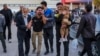 People injured in the explosions are helped outside a hospital in the southern Iranian city of Kerman on January 3.