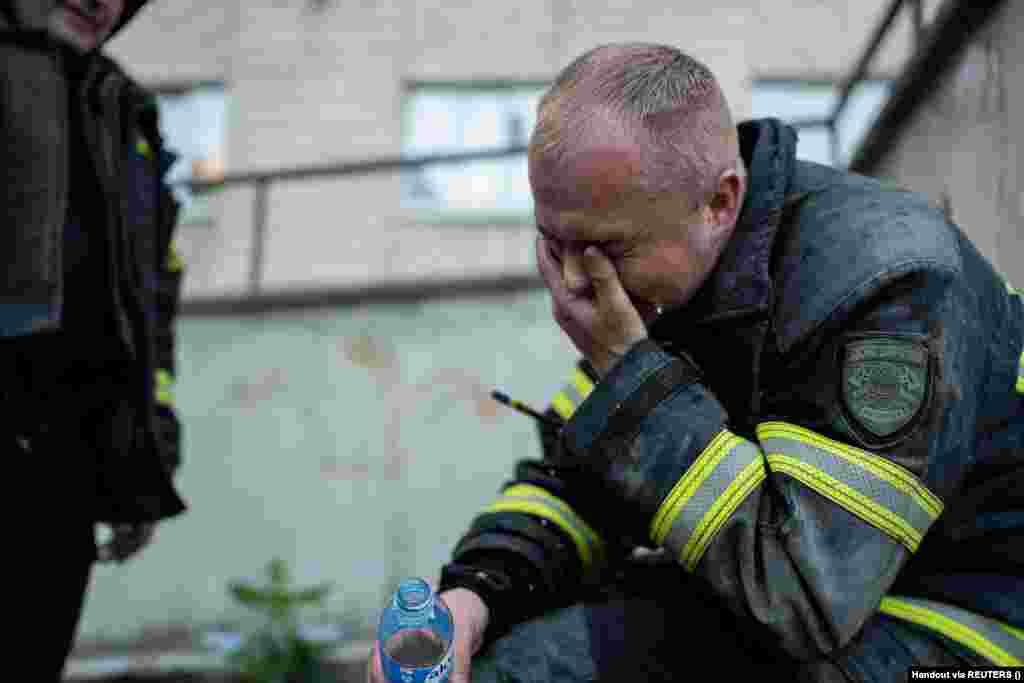 A firefighter reacts on the scene of the drone attack on the apartment building. The attack was the 17th on Kyiv in May.  