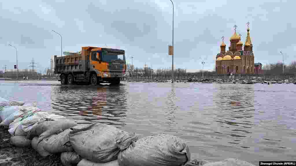 A truck drives through a flooded street in the city of Aqtobe. Officials said the massive floods were triggered by an abrupt period of warm weather that led to a huge snowmelt.
