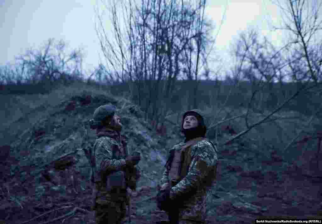 Ukrainian troops watch the sky for enemy drones at a position near Bakhmut on March 6, 2024. 