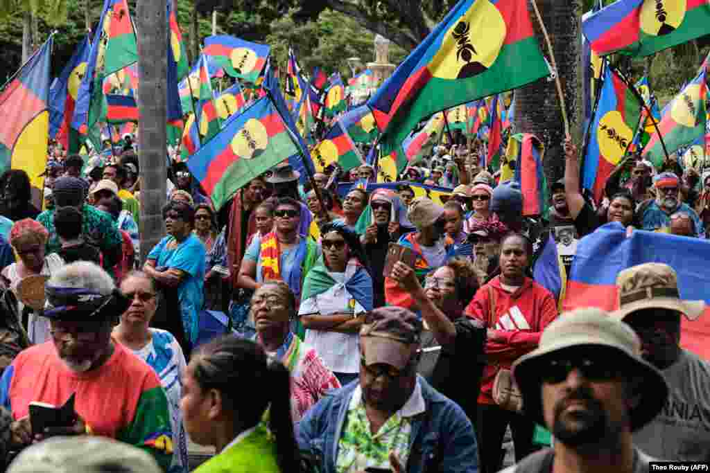 Protesters wave Kanak flags during a demonstration against the voting law on April 13.  As protests were spreading in New Caledonia, the Baku group posted a call for the "mobilization" of Kanaks on May 8 to protest the "recolonization" of New Caledonia. Since May 13, at least six people have died in the unrest.