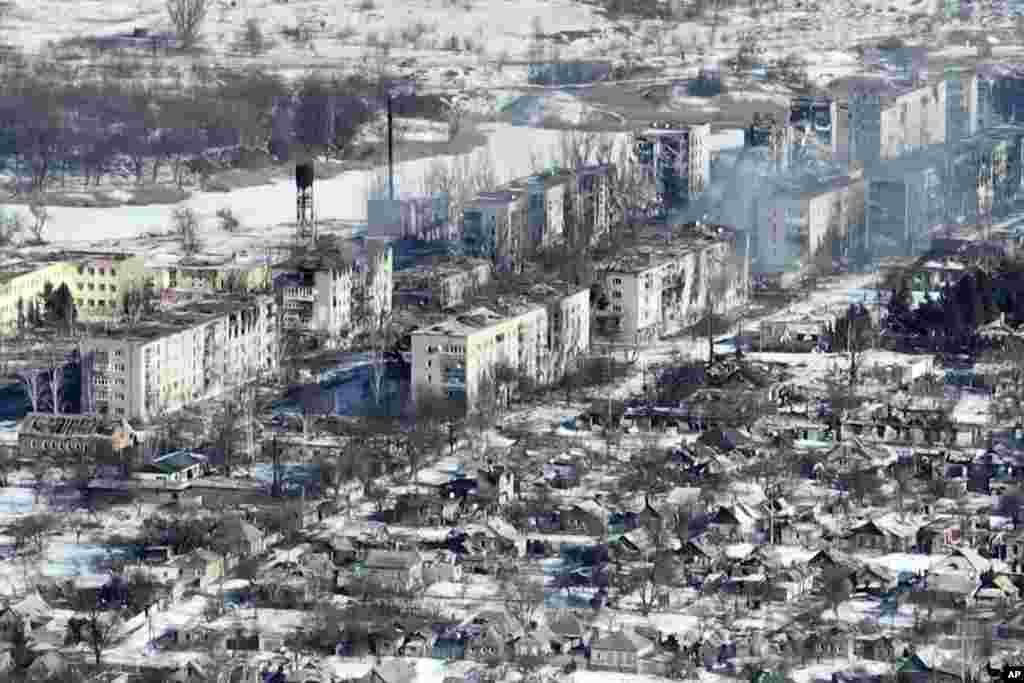 An entire row of apartment blocks have been burned out. Many buildings have only the outer walls left standing.