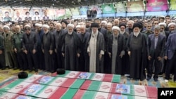 Supreme Leader Ayatollah Ali Khamenei (center) and other clerics pray over the coffins of President Ebrahim Raisi and other officials in Tehran on May 22.