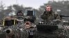 German Defense Minister Boris Pistorius rides in a tank as he visits Leopard II tanks that are due to be supplied to Ukraine at the tank brigade Lipperland of Germany's army in Augustdorf, Germany.