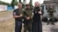 Российские волонтеры и военный "208-го казачьего полка Народной милиции ЛНР" в Рубежном, июнь 2022 года