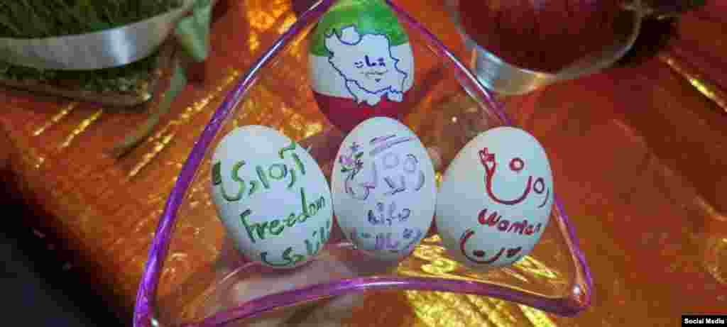 A selection of this year's Norouz eggs (Haftseen) feature the anti-government slogan "Woman, life, freedom" in Iran. Iran has been rocked by mass protests for the past six months following the death of a young woman in police custody.  Though Norouz is associated with being Persian and Iranian, the holiday is celebrated throughout Western Asia, Central Asia, the Caucasus, the Black Sea Basin, the Balkans, and South Asia.
