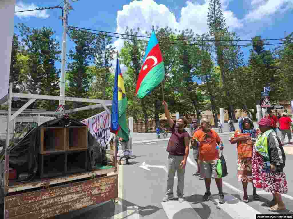 Protesters in Noumea, New Caledonia, wave an Azerbaijani flag. This January 2024 image is one of several showing flags and symbols of the distant Caucasus country being wielded by indigenous Kanak people ahead of the mass unrest that is currently roiling New Caledonia.   