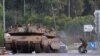 Israeli tanks are positioned near the border with Gaza in southern Israel on October 10. The White House says it has the military resources to support Israel in its war against Hamas and Ukraine.