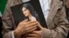 A portrait of Mahsa Amini is held during a rally calling for regime change in Iran in Washington on October 1. 