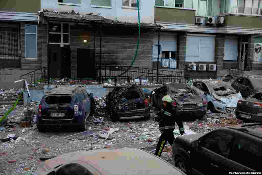 A firefighter walks near cars damaged during the Russian drone strike. Russia has intensified missile and drone strikes on Ukraine after a lull of nearly two months, targeting military facilities and supplies with waves of attacks several times a week.  