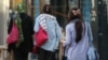 Women walk without the mandatory hijab in Iran.