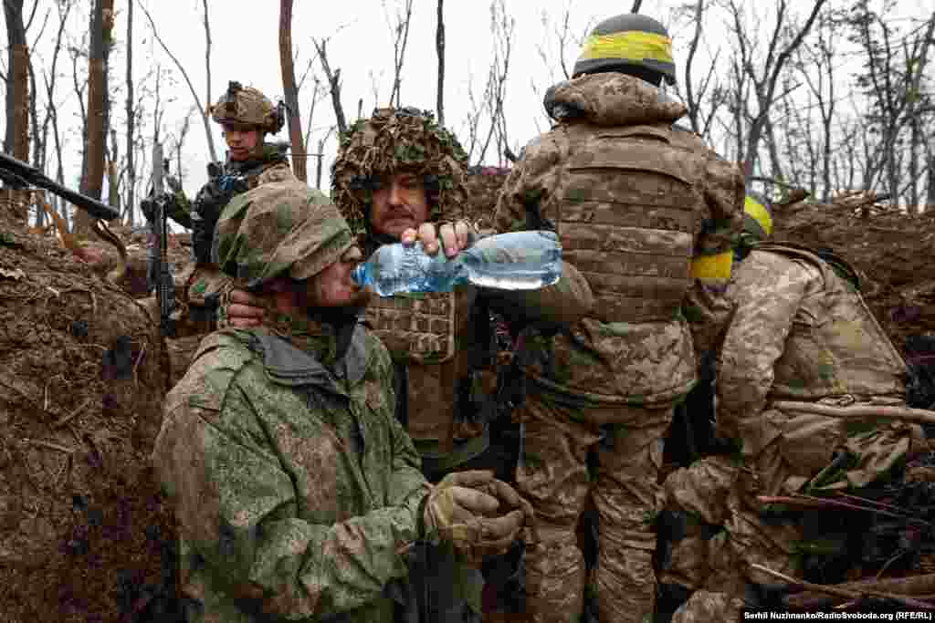A Russian soldier is given water after his capture by Ukrainian forces near Bakhmut in May, 2023. 