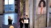 Narges Mohammadi's children hold the Nobel Peace Prize award, accepting it on behalf of their mother at Oslo City Hall on December 10.