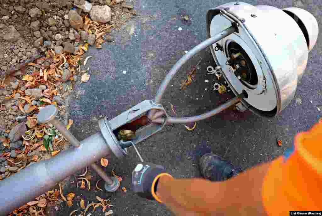 A worker dismantles a gas street lamp in Berlin on August 10.  The Kremlin appears to be using its gas-powered leverage to pressure Germany over its support for Ukraine. Flows of Russian gas through the Nord Stream 1 pipeline were cut to less than 20 percent of capacity in July, with Russia's Gazprom citing "equipment repairs" for the strangled gas flow. 