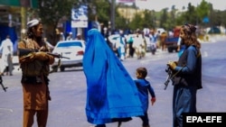 Taliban security stand guard on the street in Kabul on August 11.