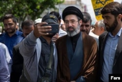 Mojtaba Khamenei (center) lacks administrative experience and will likely face allegations of nepotism if he succeeds his father.