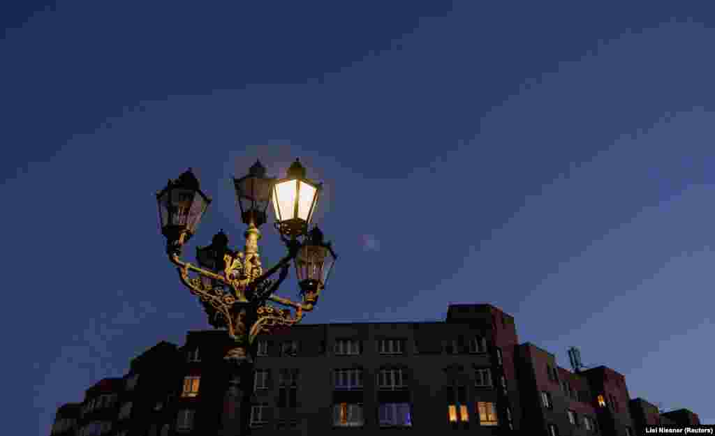 Gas lanterns are lit at a minimum in Berlin.  The power-saving measures are part of an attempt by Germany to reduce its energy consumption and stockpile gas as supplies from Russia become increasingly uncertain.