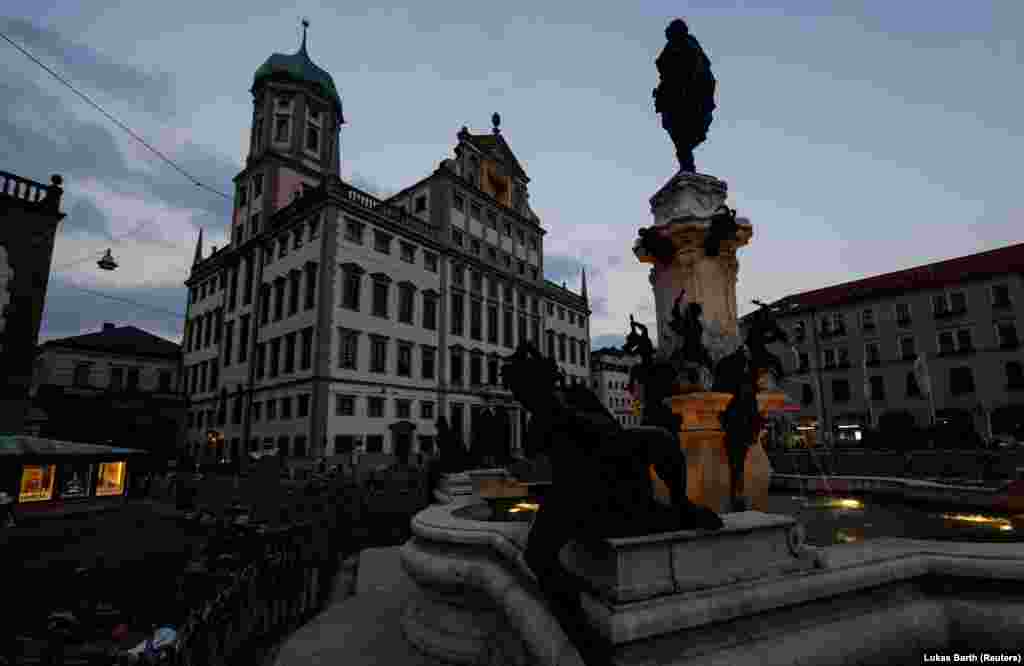 The town hall of Augsburg and the surrounding square are normally brightly lit in the evening.  From September, Germany's rail network will prioritize trains carrying coal and oil, meaning passenger trains will need to wait as the fuel wagons move through. 