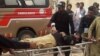 Police officers carry an injured colleague on a stretcher following a bomb blast in Sibi, a city in the southwestern Pakistani province of Balochistan, on March 8.