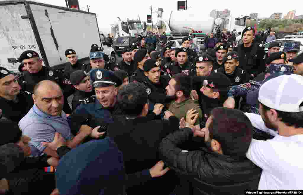 A scuffle breaks out near the trucks on Yerevan's Kievyan Bridge on May 4. Roadblocks were a key part of the protests that brought Prime Minister Nikol Pashinian to power in the spring of 2018. 