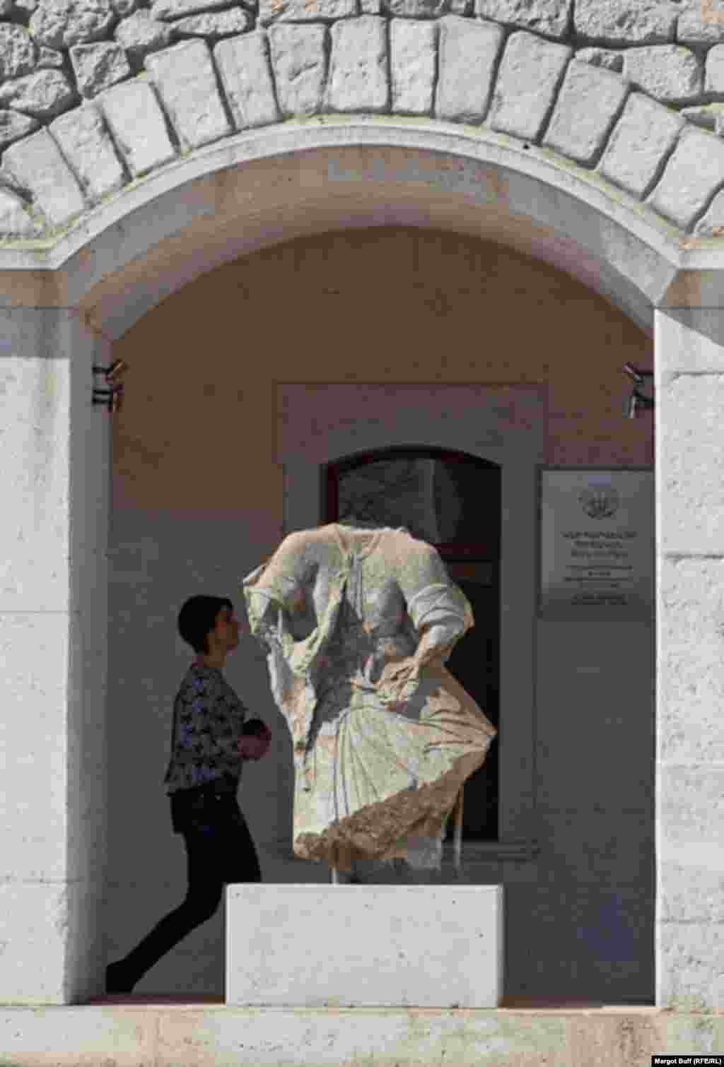 A damaged sculpture from the Ghazanchetsots Cathedral now stands in front of a museum.