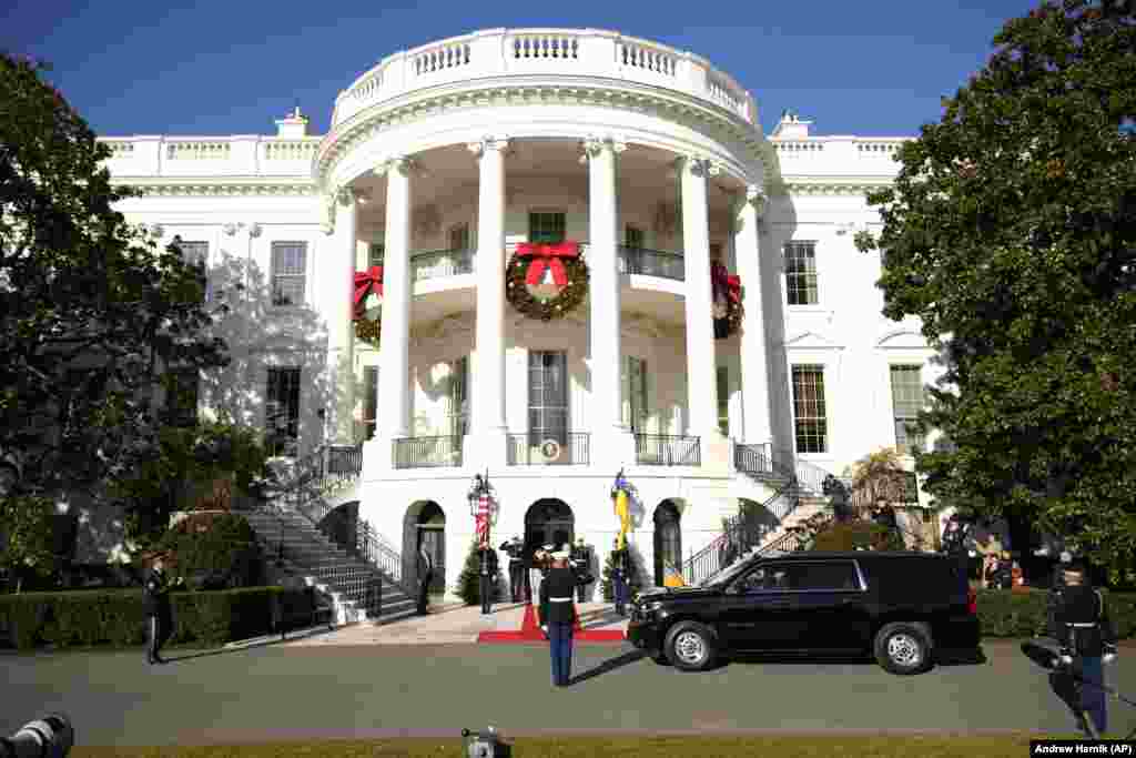 Ukrainian President Volodymyr Zelenskiy arrives at the White House in Washington on December 21 to be welcomed by U.S. President Joe Biden and first lady Jill Biden.  It was the Ukrainian president's first foreign trip since the start of Russia's invasion 10 months ago.
