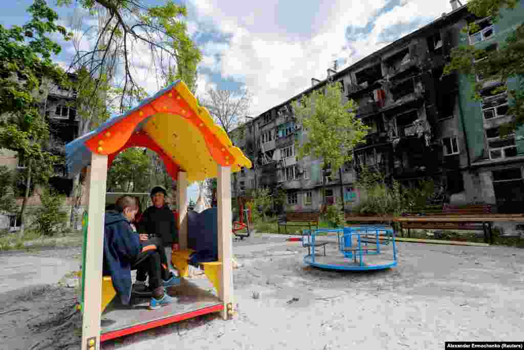 Children gather at a playground  surrounded by destroyed apartment buildings on March 11.