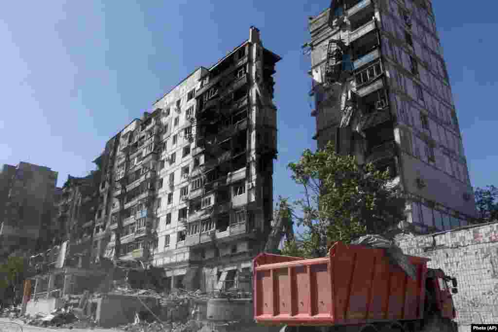 Workers clear rubble from a residential area on May 12. 