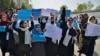 Afghan women and girls take part in a protest demanding that high schools be reopened for girls.