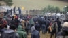 Migrants remonstrate with Polish border guards in Belarus's Hrodno region on November 8.