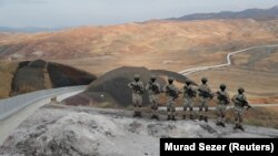 Turkish forces man the new border wall along the Turkish-Iranian border in Turkey's Van Province.