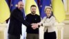 Ukrainian President Volodymyr Zelenskiy (center) European Commission President Ursula von der Leyen (right) and European Council President Charles Michel shake hands during their EU-Ukraine summit in Kyiv on February 3.