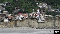 Flood-damaged buildings along the Swat River in Pakistan.