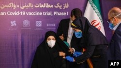 A woman receives an injection during the first trial phase of a locally made Iranian vaccine for COVID-19 in Tehran on December 29.
