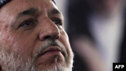 Afghan President Hamid Karzai announces the first phase of the NATO transition on March 22.