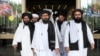 Members of a Taliban delegation, led by chief negotiator Mullah Abdul Ghani Baradar (center, front), leave after peace talks with Afghan senior politicians in Moscow on May 30, 2019.