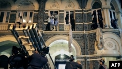 Employees and guests of the Taj Mahal hotel are recued by firefighters