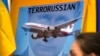 Изображение президента РФ Владимира Путина на плакате участников акции протеста в столице Австралии спустя два дня после сбитого 17 июля российскими гибридными силами. Сидней, 19 июля 2014 года
