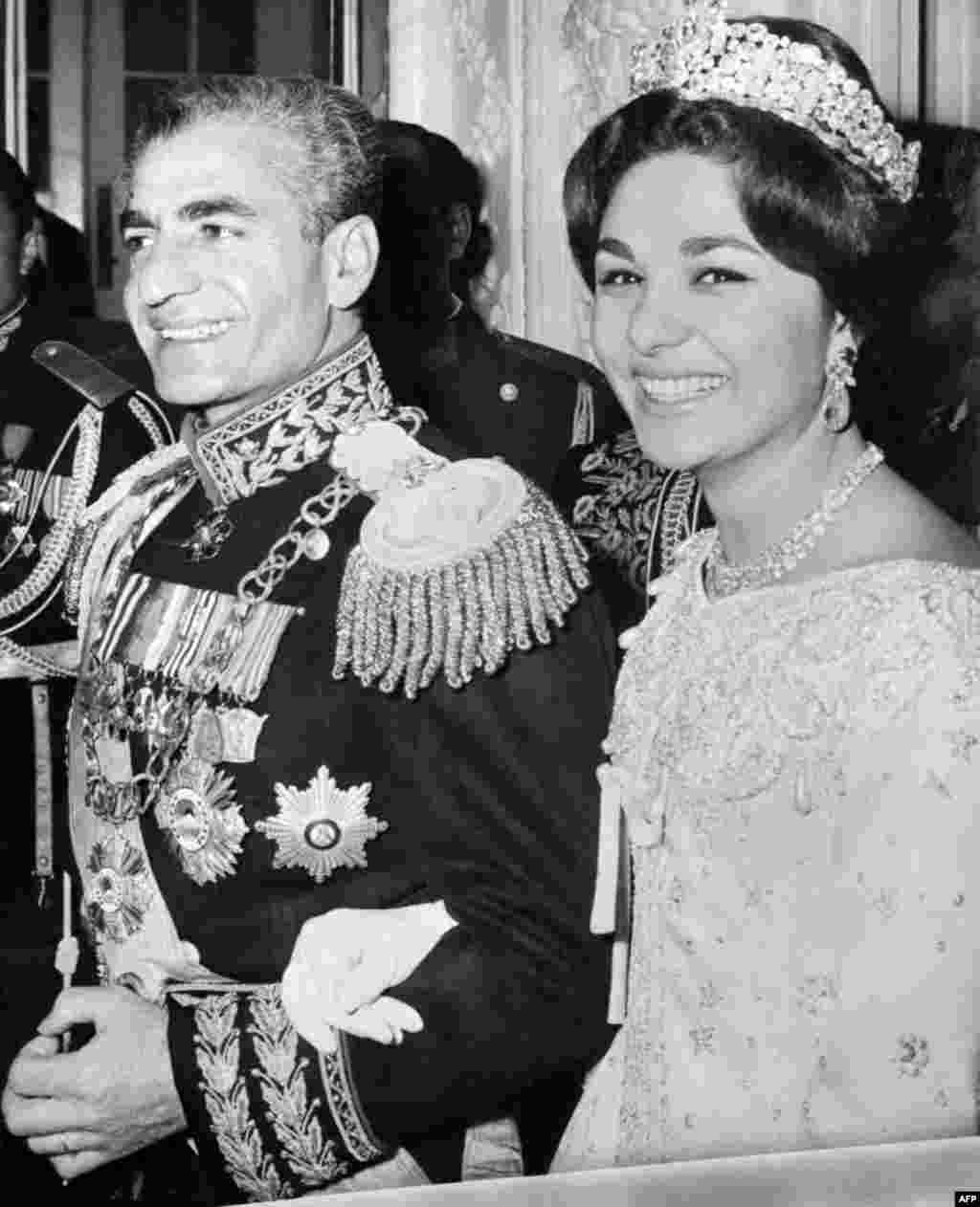 The shah of Iran, Mohammad Reza Pahlavi, and his wife, Farah (née Diba), are photographed during their wedding ceremony in Tehran on December 21, 1959. 