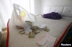 Foreign currency banknotes and various documents are seen in the bedroom where the alleged attacker was caught by Turkish police in the Esenyurt neighborhood of Istanbul.