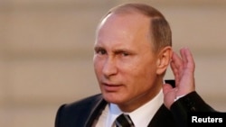 Путин прислушивается к вопросу после переговоров в Париже по украинской проблеме с Меркель, Олландом и Порошенко. 2 октября 2015 года.