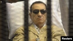 Former President Hosni Mubarak sits inside a cage in a courtroom in Cairo during sentencing on June 2.