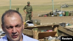 Daghestan's President Magomedsalam Magomedov speaks to the media at a blast site in a military camp outside the town of Buynaksk on September 5.