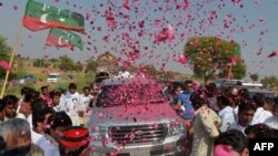 People welcome the convoy of cricket star turned politician Imran Khan on his way to a rally in Pakistan's tribal areas. His Tehreek-e Insaaf party is seen as somehting of a wild card in the country's upcoming parliamentary elections.