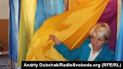 A woman casts her vote in Ukraine's regional elections