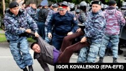 Police detain opposition supporters during a protest calling for free and fair elections during the presidential election in Nur-Sultan, Kazakhstan, in June 2019.