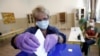 A woman casts her ballot under coronavirus health protocols during the August 30 parliamentary elections.