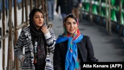 Iranian women wearing hijabs on a street in the capital, Tehran.