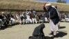 An Afghan judge hits a woman with a whip in front of a crowd in Ghor Province. (file photo)